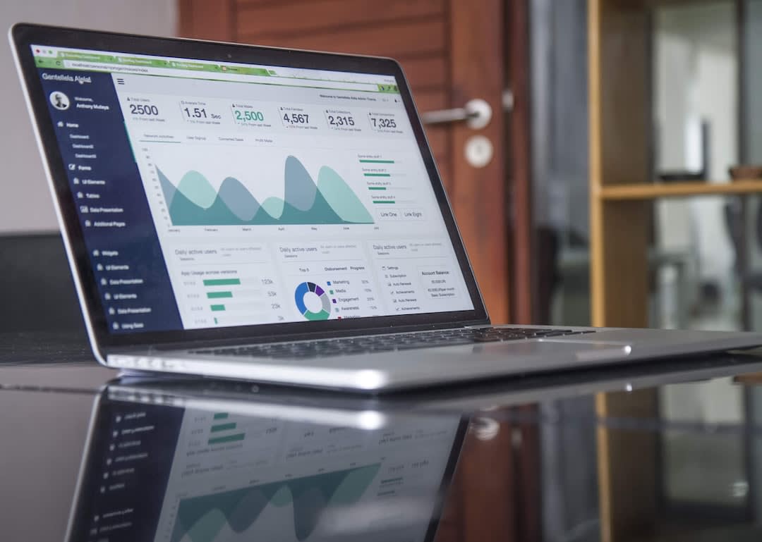 Laptop displaying a dashboard with statistics